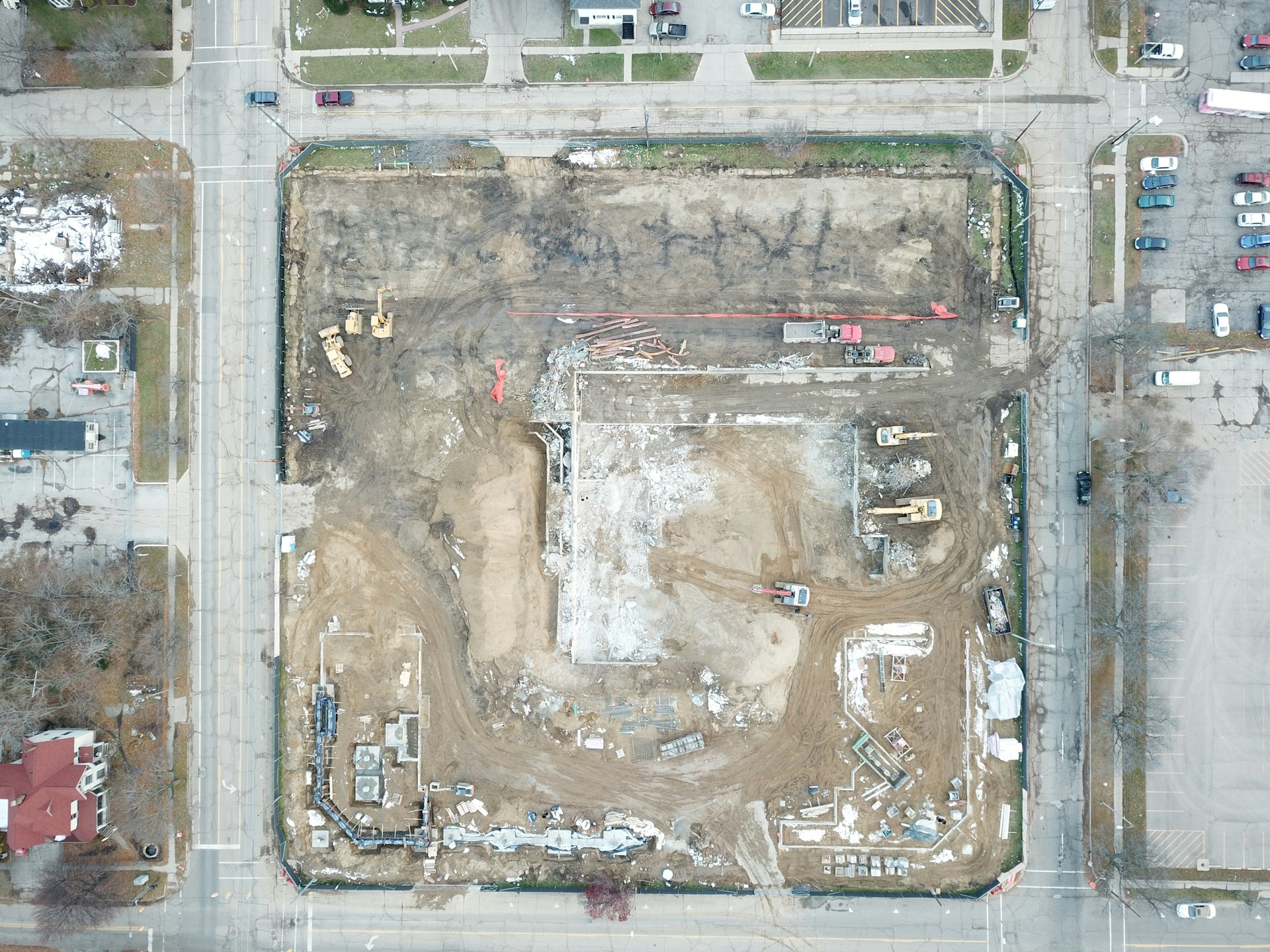 Aerial view of an industrial parcel with high-voltage transmission line in the distance.